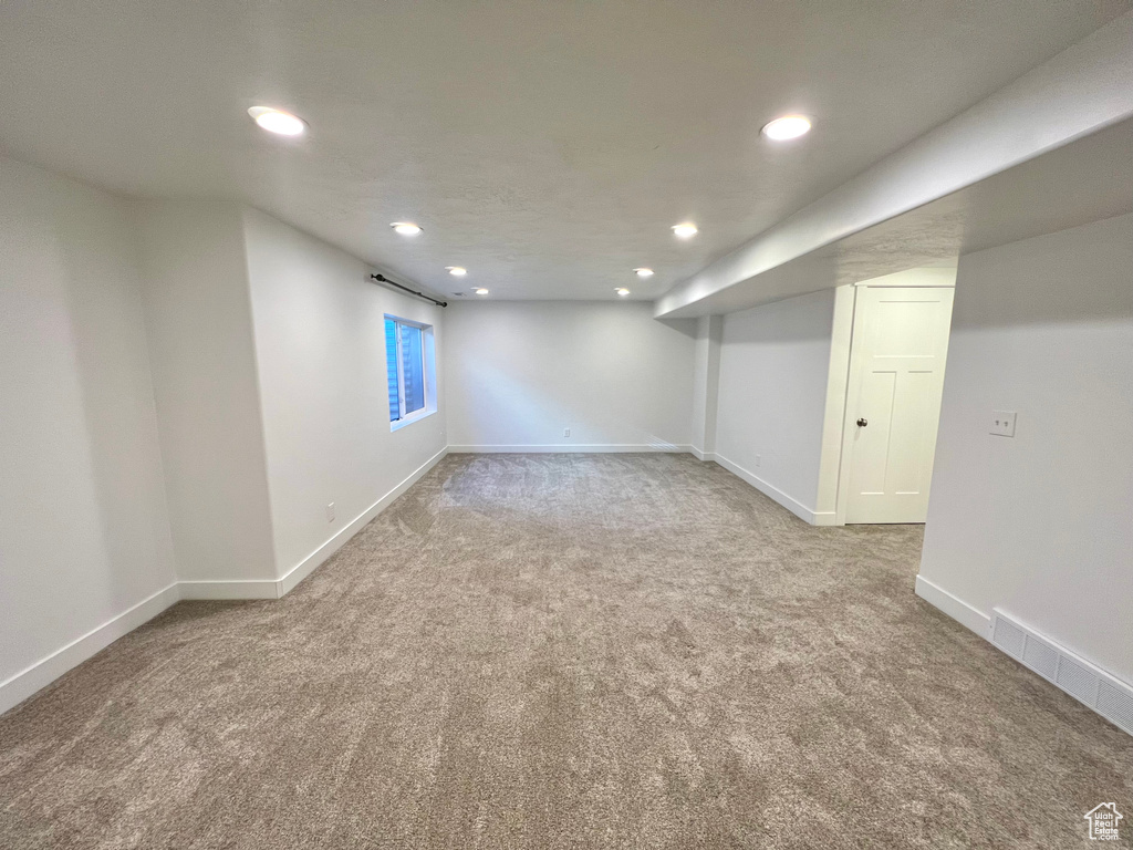 Below grade area featuring recessed lighting, carpet, visible vents, and baseboards