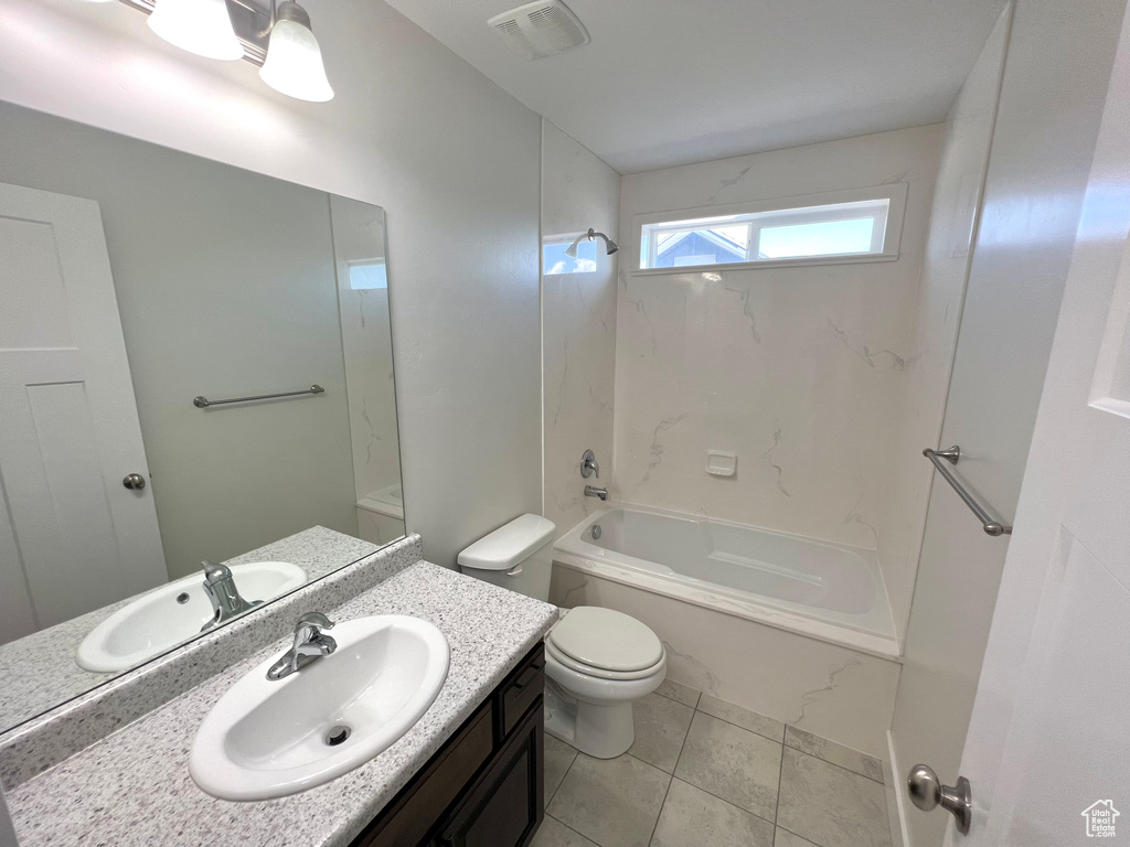 Full bathroom with visible vents, toilet,  shower combination, tile patterned flooring, and vanity