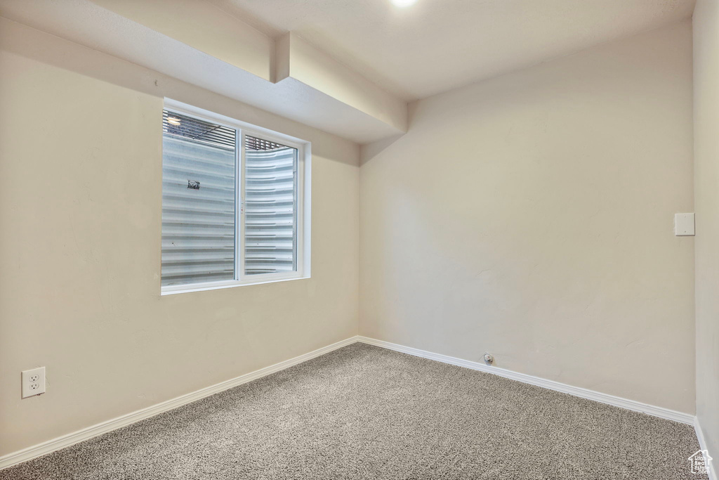 Empty room with carpet and baseboards