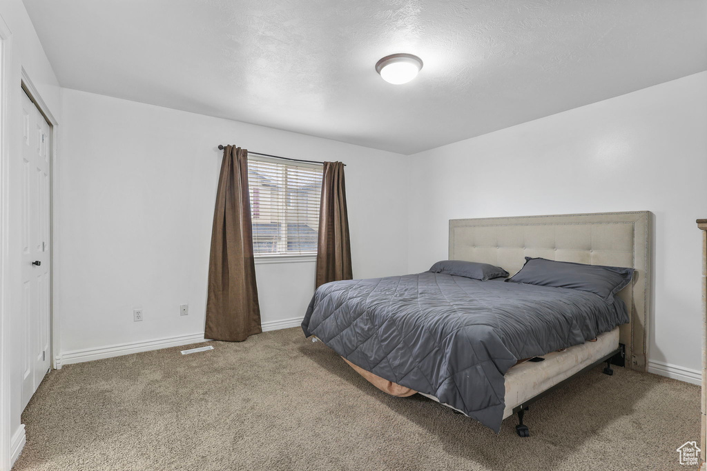 Carpeted bedroom with baseboards