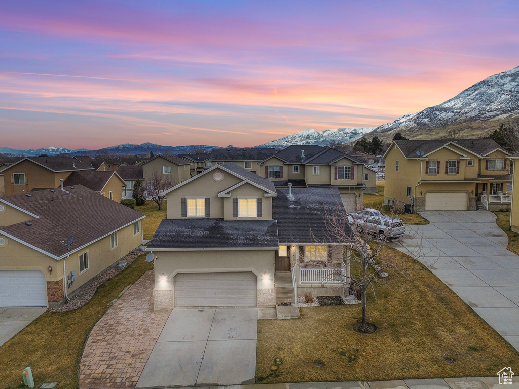 Traditional-style house featuring a residential view, a mountain view, and driveway