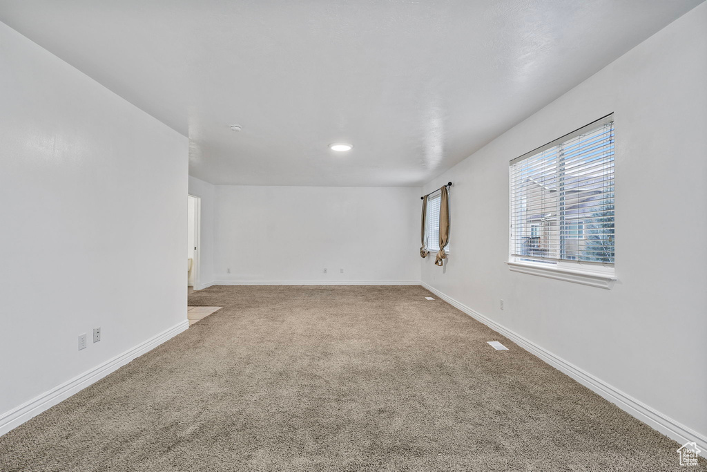 Unfurnished room with carpet floors and baseboards