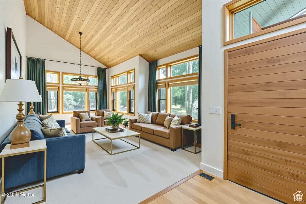 Living room featuring wood finished floors, wood ceiling, and high vaulted ceiling