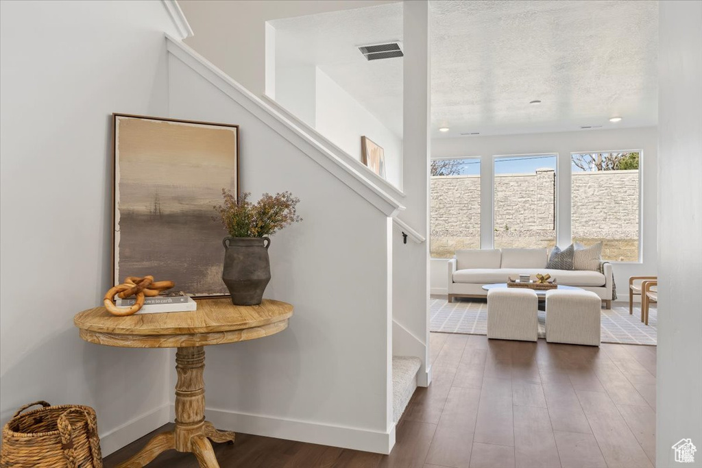 Interior space featuring baseboards, visible vents, and wood finished floors