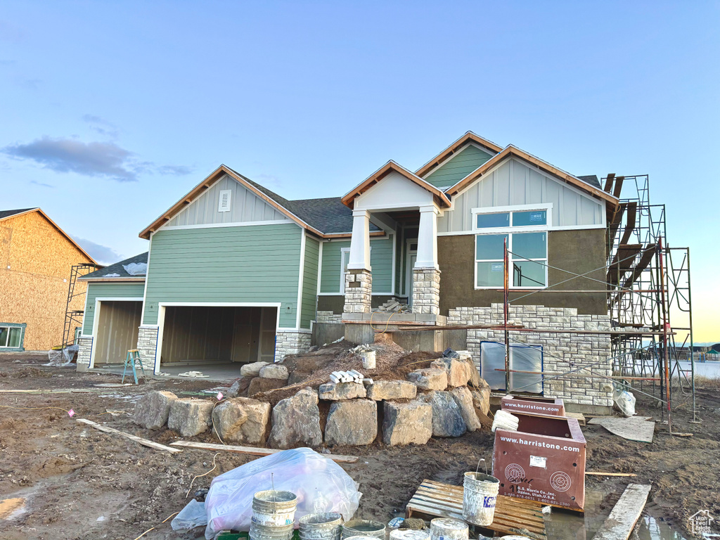 View of front of home with stone siding and board and batten siding
