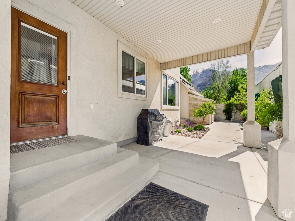 View of patio / terrace with fence and a mountain view