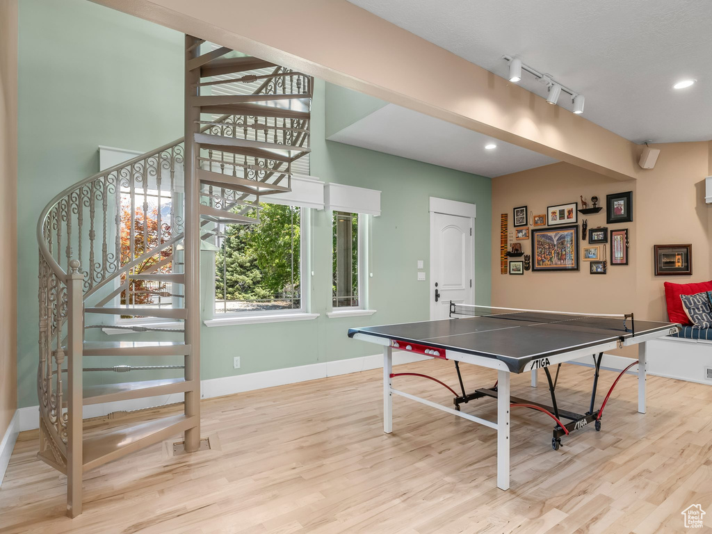 Playroom featuring wood finished floors, baseboards, and recessed lighting