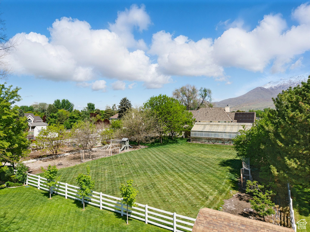 View of yard with an exterior structure, a mountain view, and an outbuilding