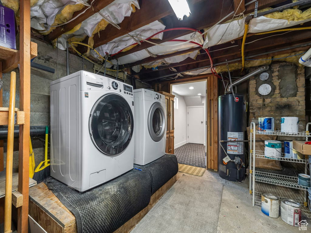 Clothes washing area featuring gas water heater and independent washer and dryer
