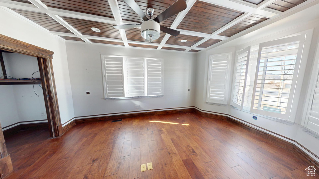Unfurnished bedroom featuring hardwood / wood-style flooring, baseboards, coffered ceiling, and beam ceiling