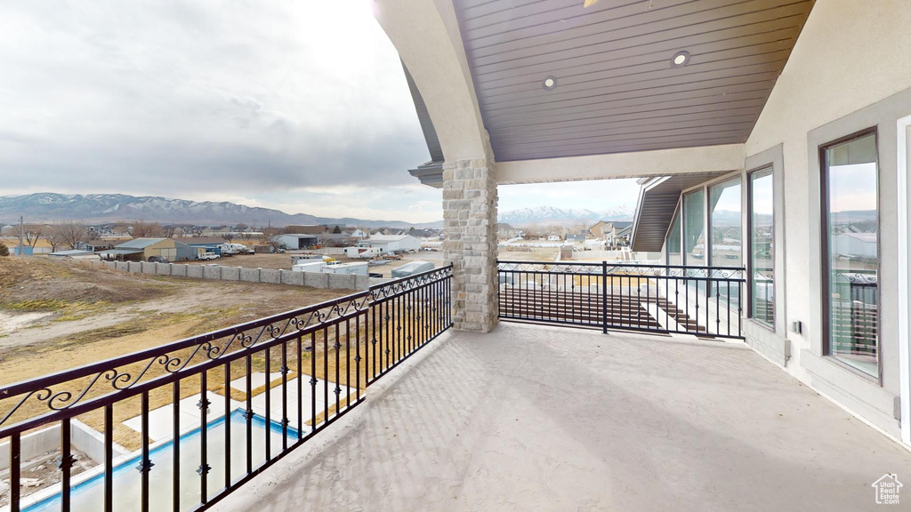 Balcony featuring a residential view and a mountain view