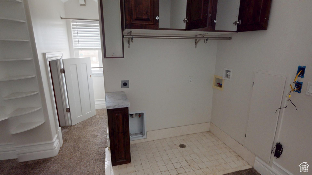Laundry room with baseboards, washer hookup, cabinet space, and hookup for an electric dryer