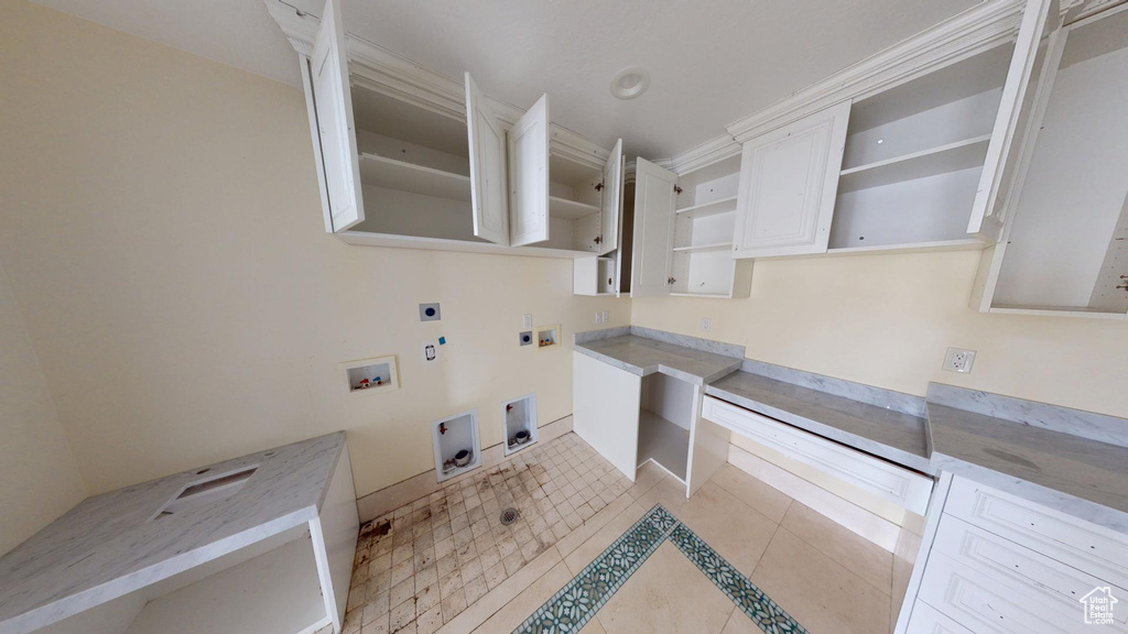Clothes washing area featuring laundry area, hookup for a gas dryer, hookup for a washing machine, hookup for an electric dryer, and light tile patterned flooring
