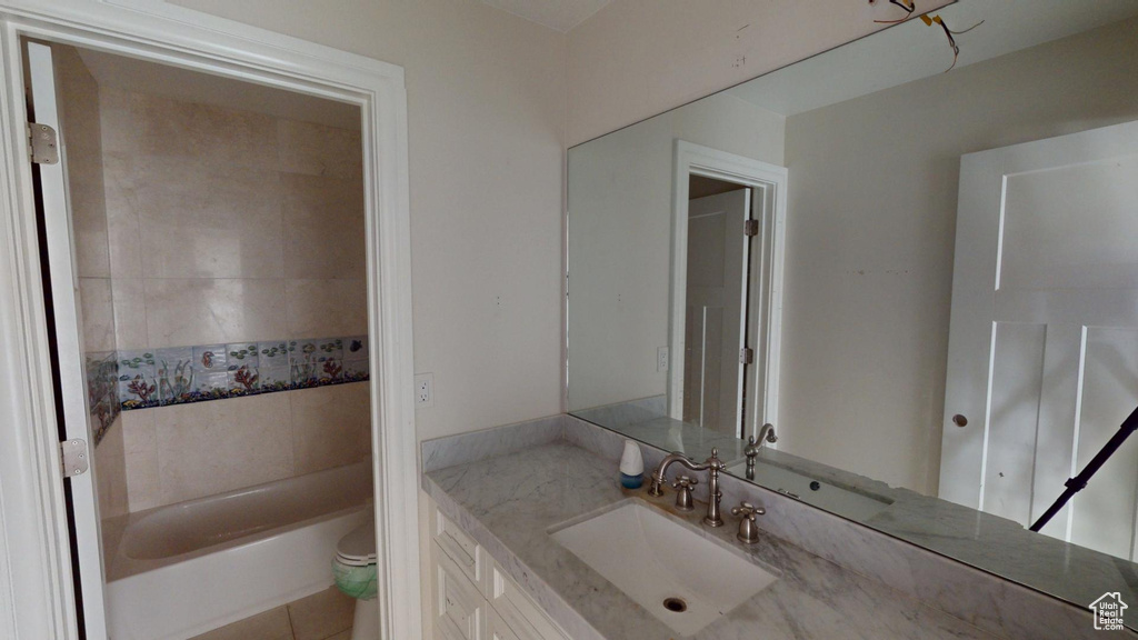 Full bath featuring toilet, shower / bathtub combination, and vanity