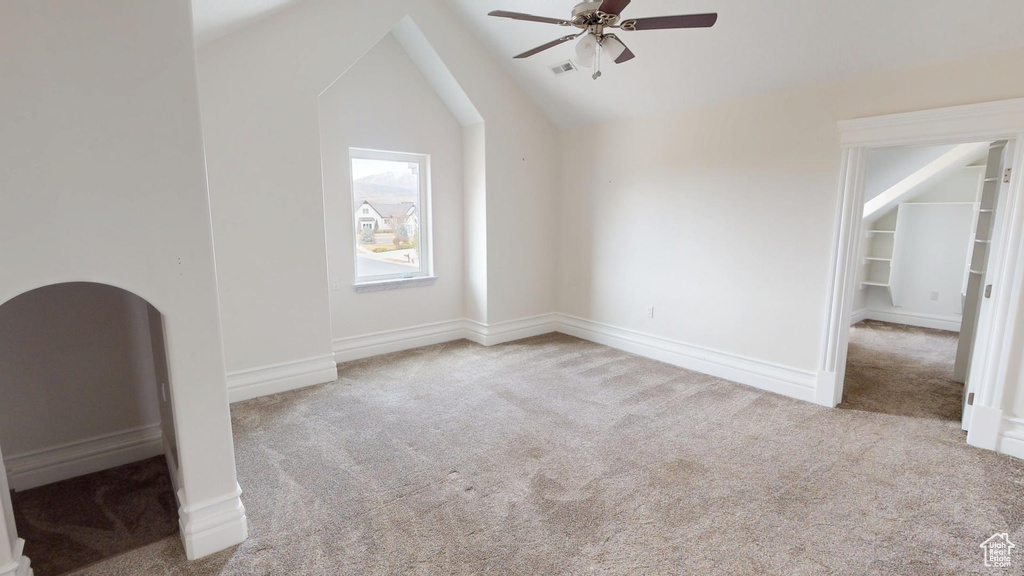 Bonus room with a ceiling fan, carpet, and lofted ceiling