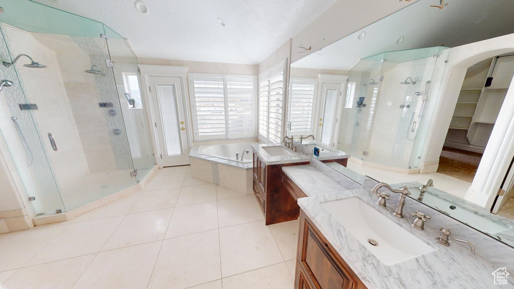 Bathroom with a garden tub, a shower stall, vanity, and tile patterned floors
