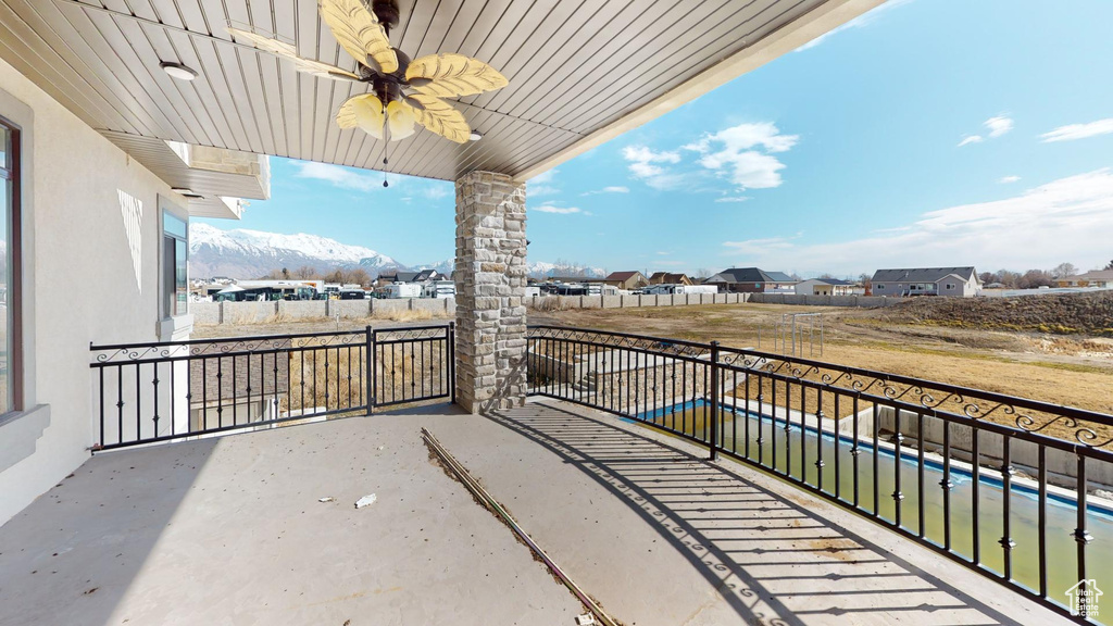 Balcony featuring ceiling fan and a mountain view