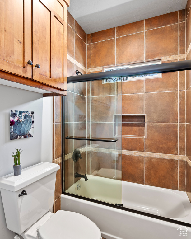 Full bath with enclosed tub / shower combo and toilet
