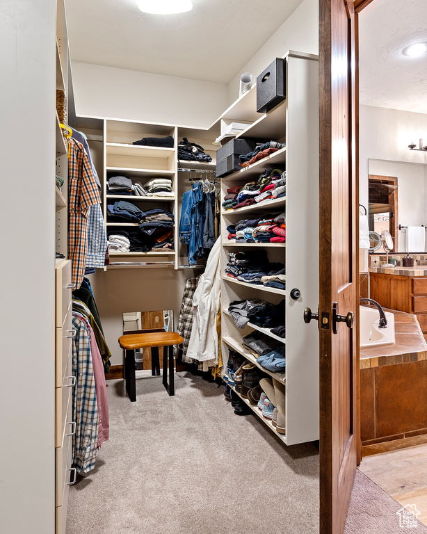 Walk in closet featuring carpet flooring