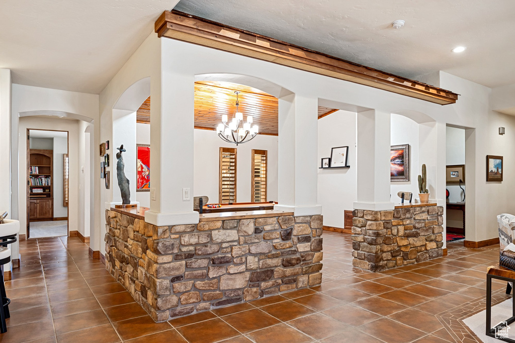 Interior space with an inviting chandelier and arched walkways