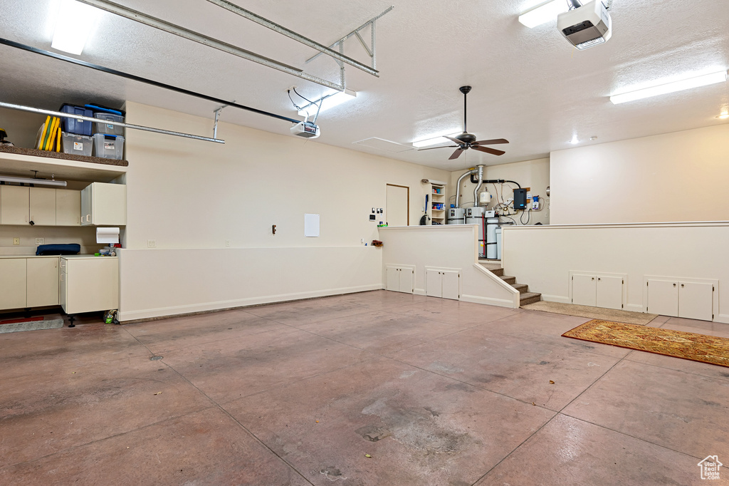 Garage with baseboards and a garage door opener