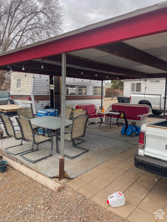 View of patio with a carport