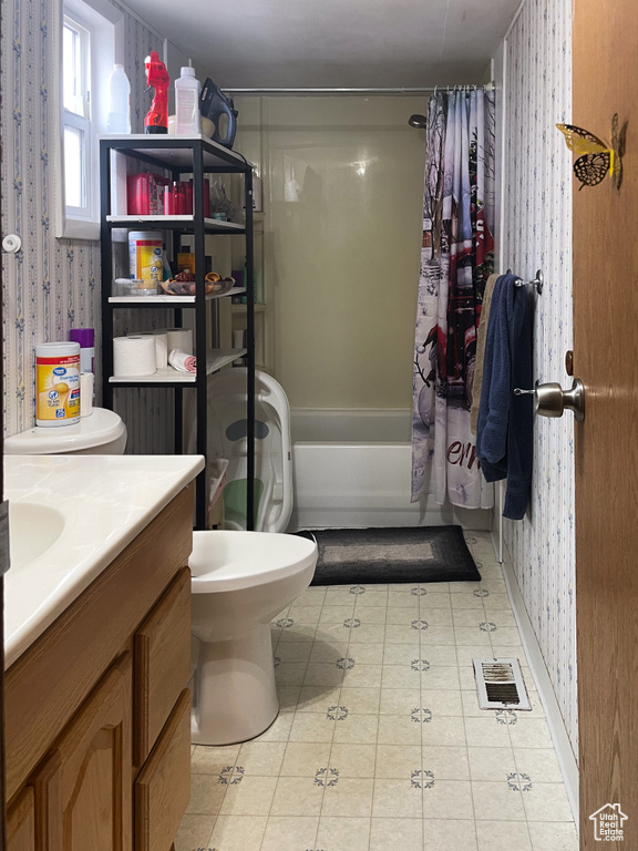 Bathroom featuring shower / tub combo, wallpapered walls, visible vents, toilet, and vanity