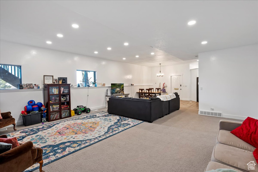 Living room featuring recessed lighting, light colored carpet, and visible vents