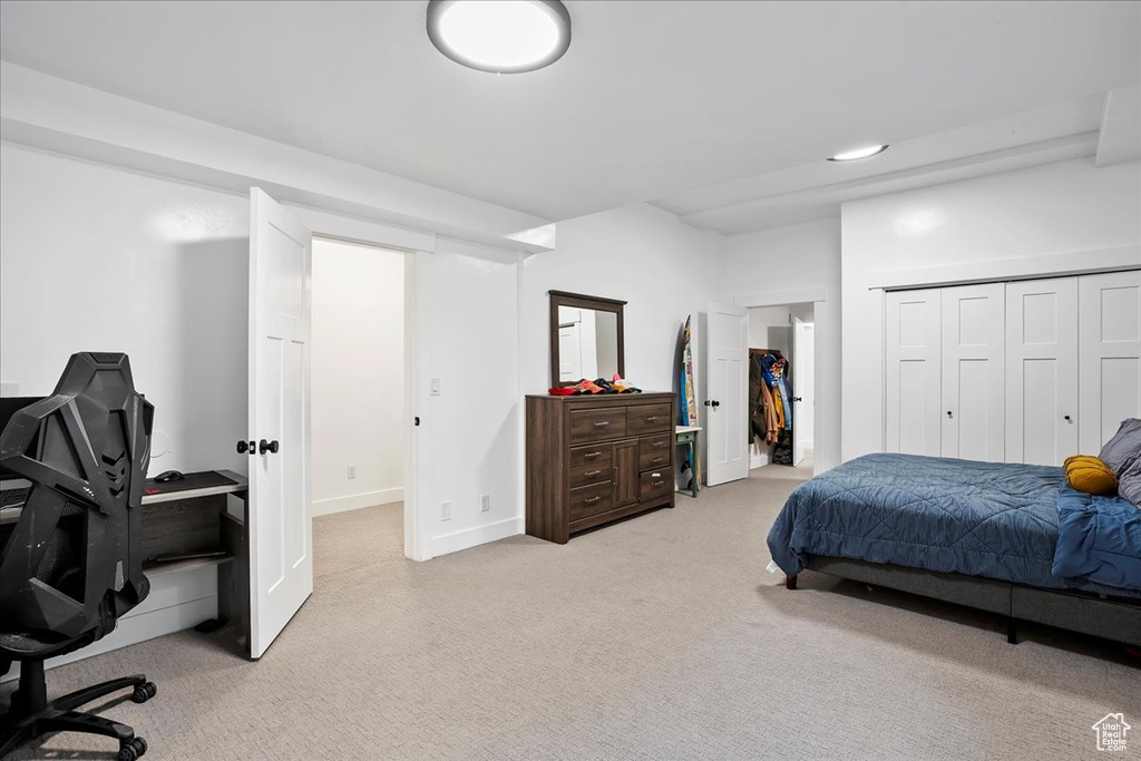 Bedroom featuring baseboards and light colored carpet