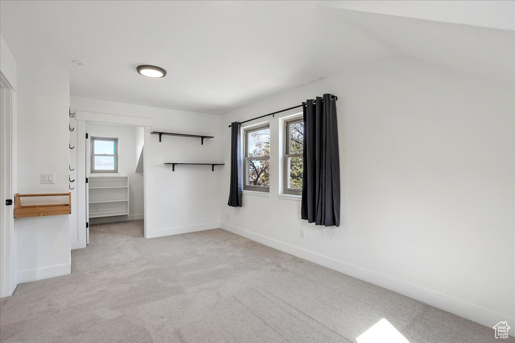 Carpeted spare room with baseboards