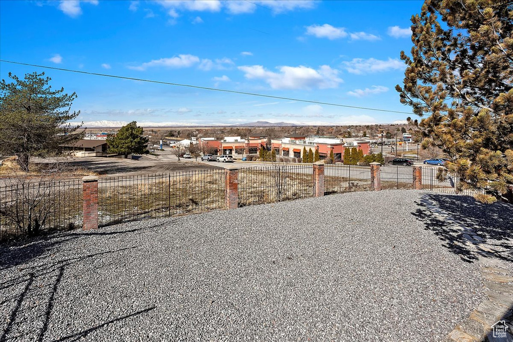 View of yard with a residential view and fence