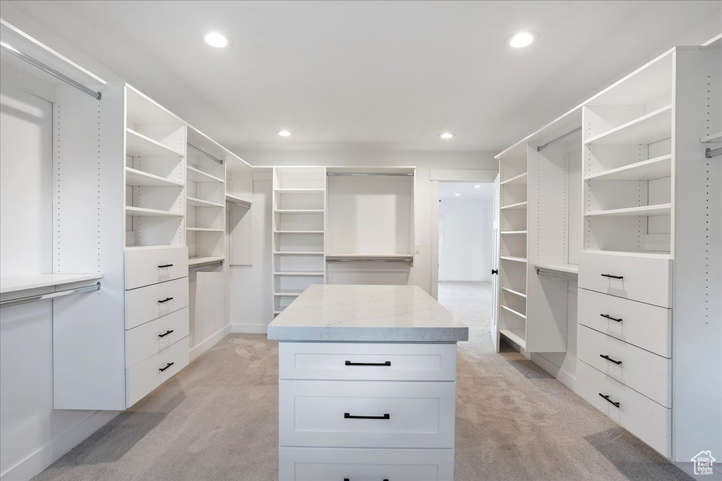 Walk in closet with light carpet