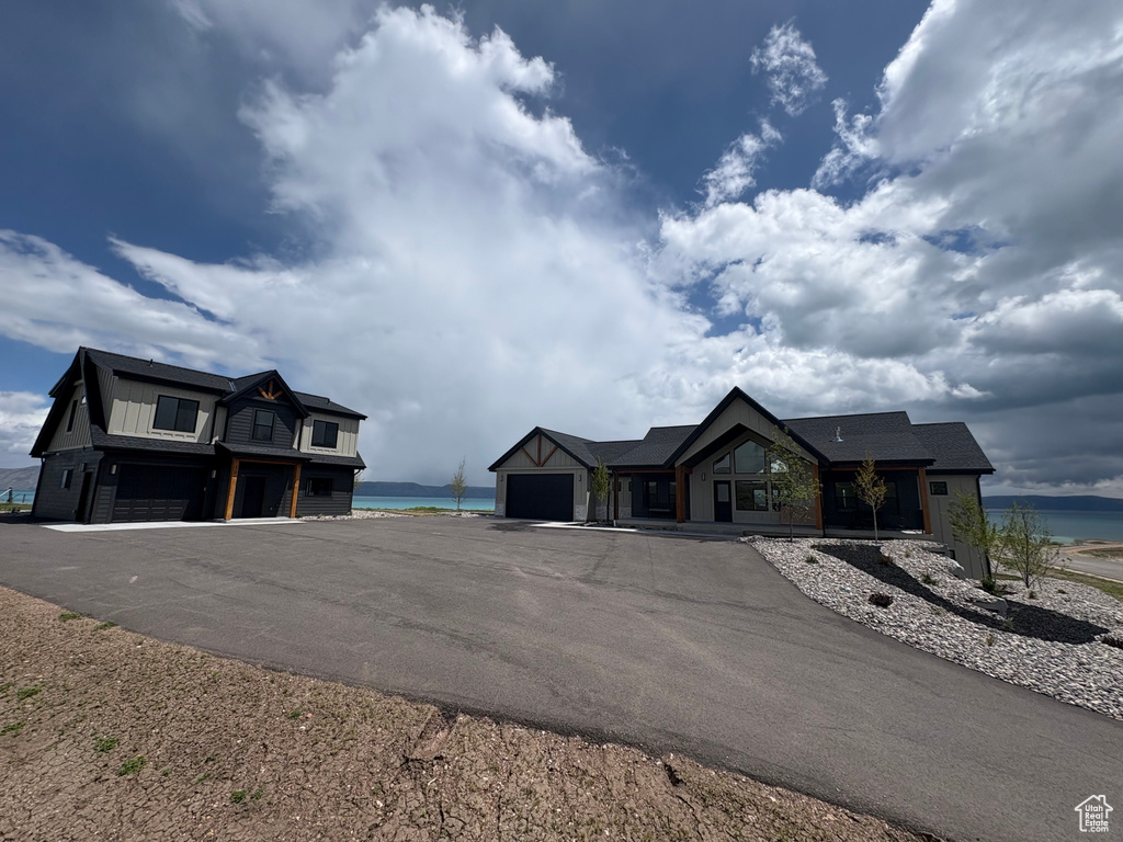 View of asphalt driveway with a water view