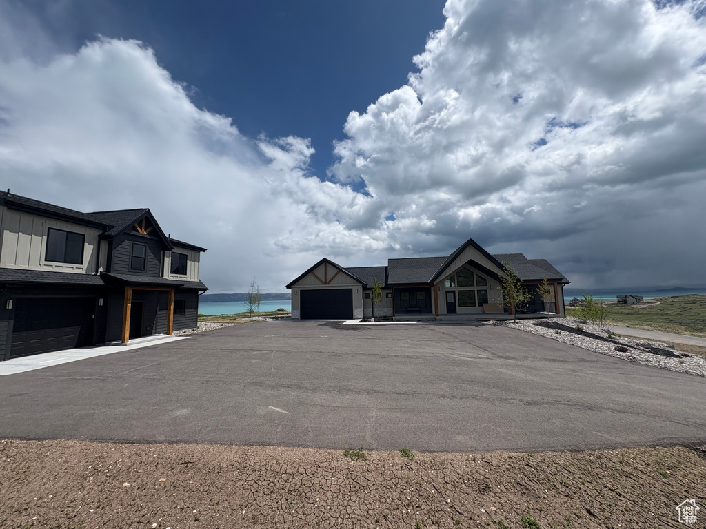 View of front of home with a water view, board and batten siding, and a garage