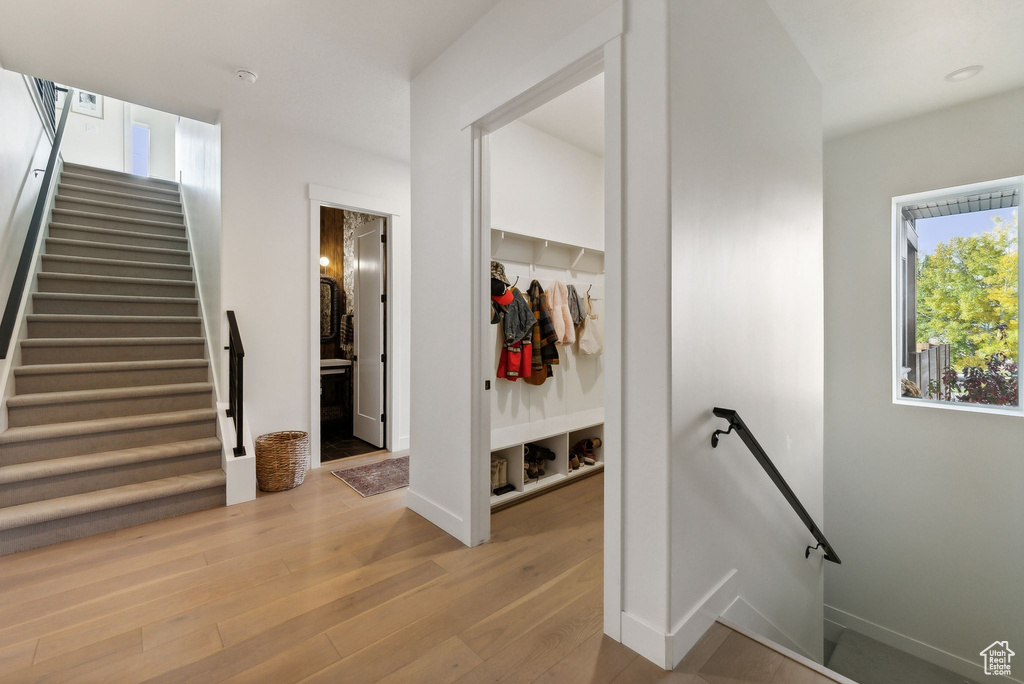 Stairway featuring baseboards and wood finished floors