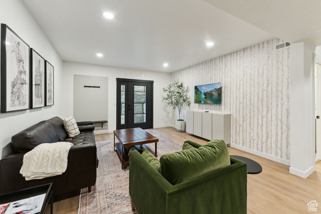 Living room featuring recessed lighting, wood finished floors, baseboards, french doors, and wallpapered walls