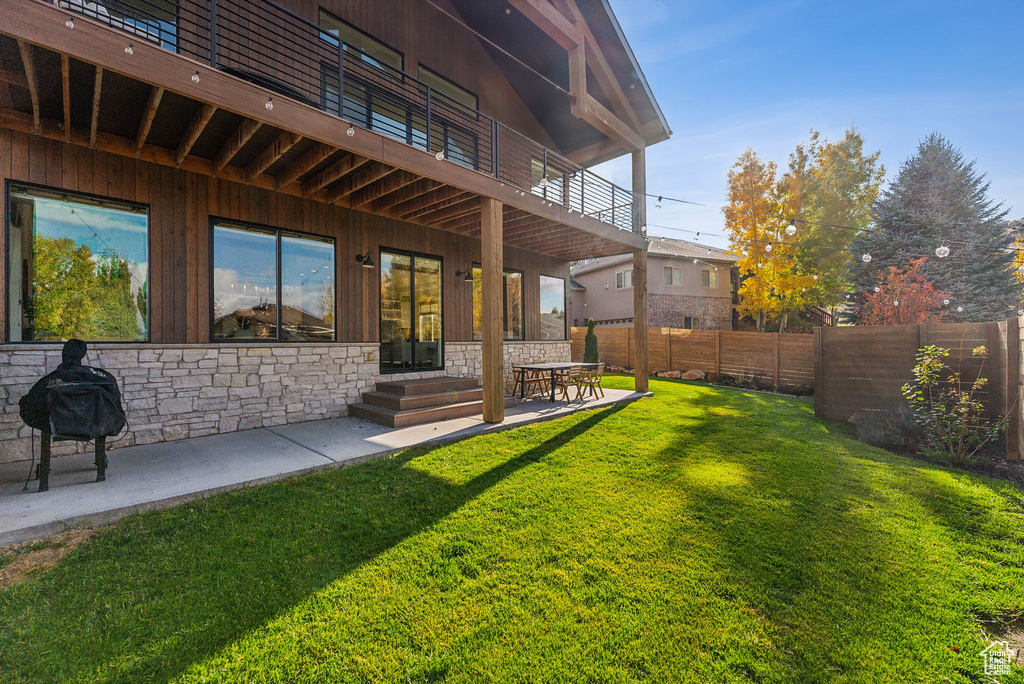 View of yard with a patio area and fence