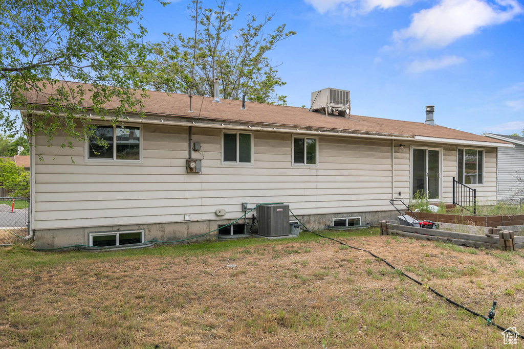 Rear view of property featuring central AC unit