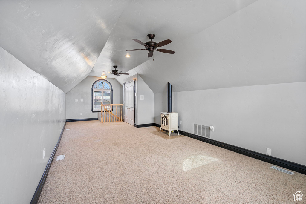 Bonus room featuring lofted ceiling, baseboards, and visible vents