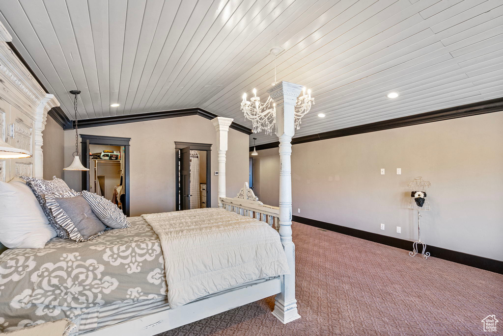 Bedroom with baseboards, carpet, vaulted ceiling, crown molding, and ornate columns