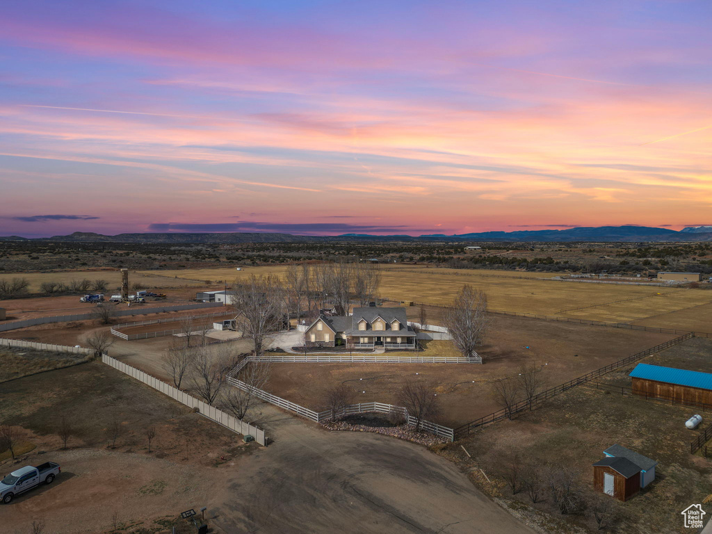 Aerial view at dusk featuring a rural view and a mountain view