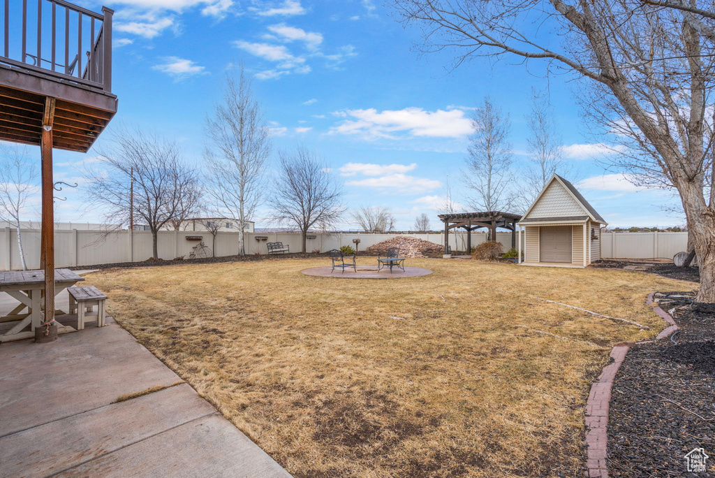 View of yard featuring a deck, a patio area, a fenced backyard, and a pergola