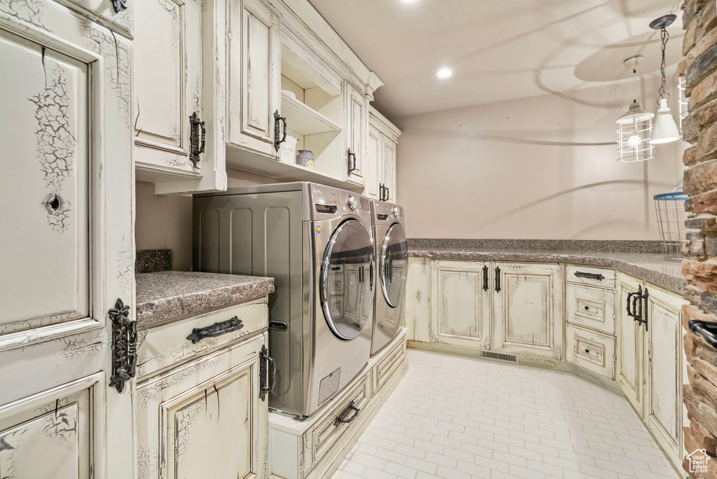 Laundry area with washing machine and dryer, cabinet space, visible vents, and recessed lighting