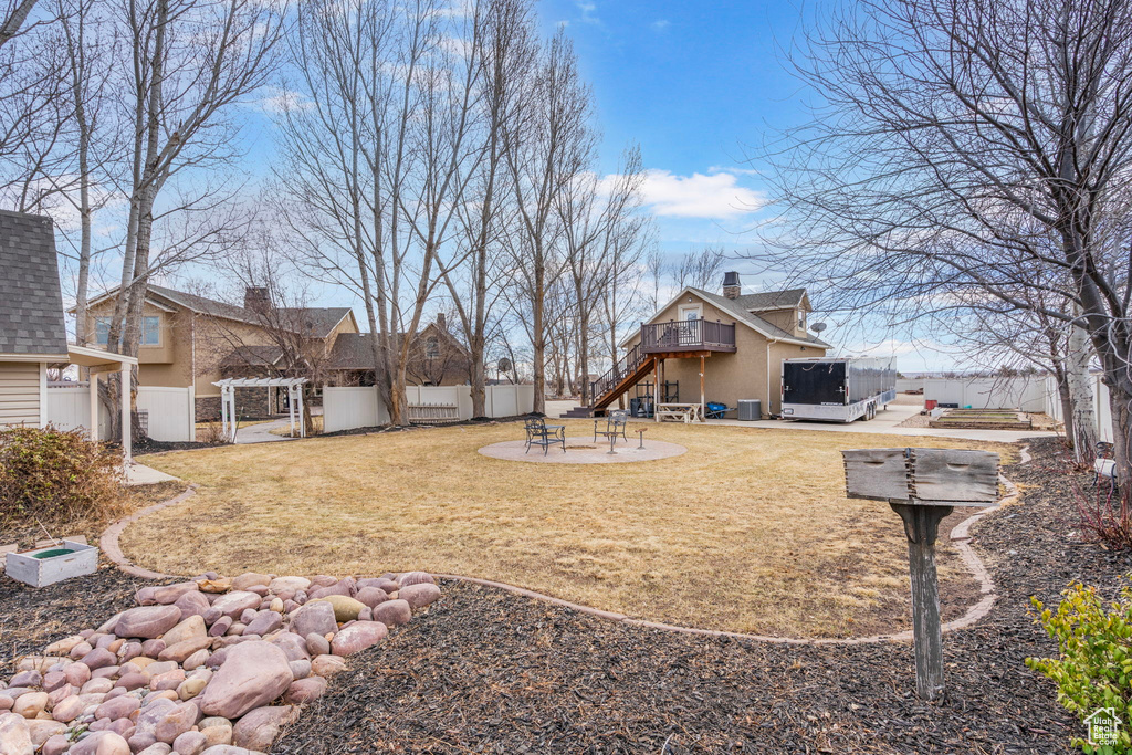 View of yard featuring a fenced backyard, stairs, a deck, a patio area, and a pergola