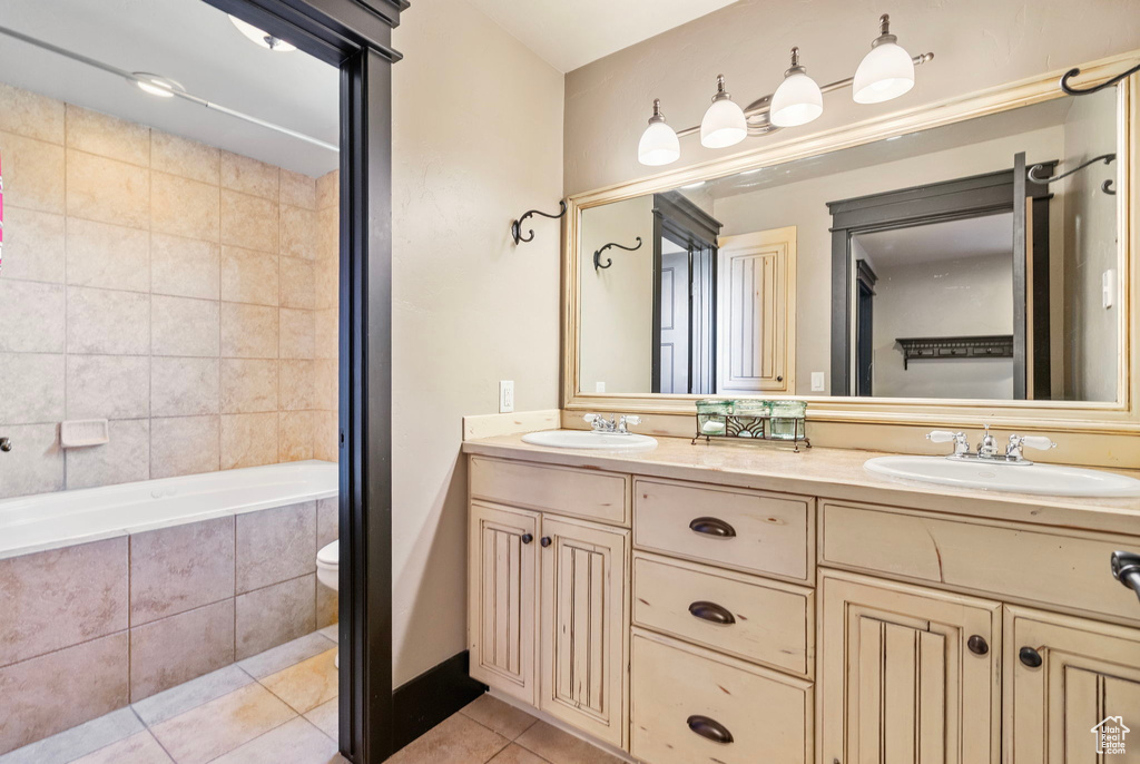 Full bathroom with tile patterned flooring, a sink, and double vanity