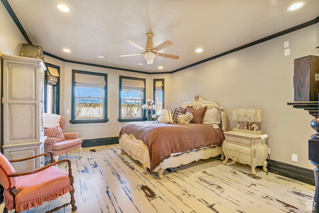 Bedroom featuring ornamental molding and wood finished floors