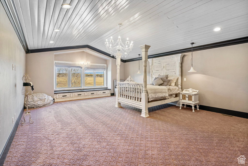 Bedroom with lofted ceiling, a notable chandelier, baseboards, carpet, and crown molding