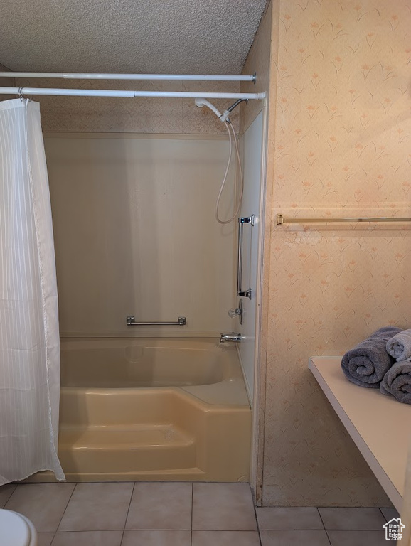 Full bath with wallpapered walls, a textured ceiling, shower / tub combo with curtain, and tile patterned floors
