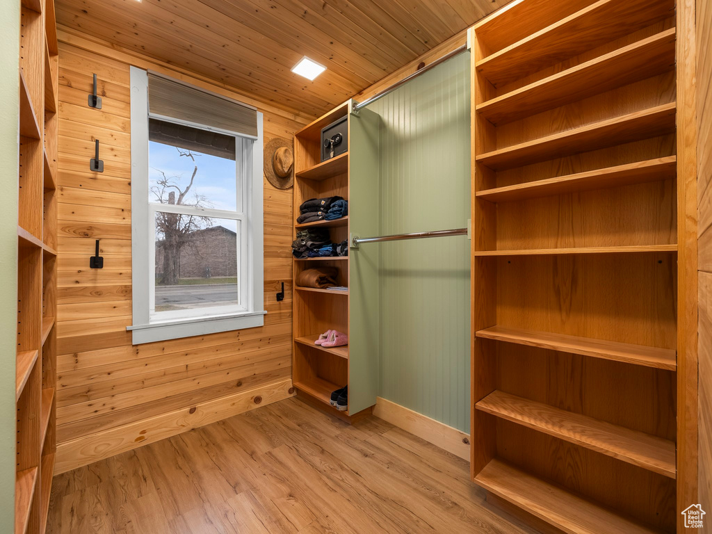 Walk in closet with wood finished floors