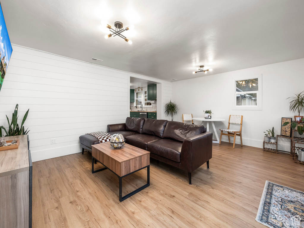 Living room featuring light wood-style flooring and baseboards